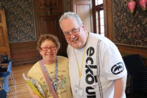 Two people supported by citizens Options Unlimited enjoy the Compass Reaccreditation party.