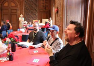 Self-advocates gathered around a table at the Personal Outcome Measures (POMs) Rally.