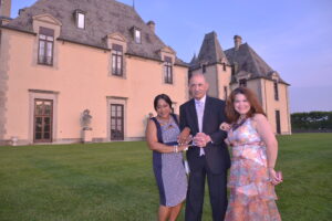 Three Rose Ball attendees in front of Oheka Castle