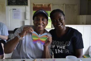 Camp Loyaltown campers show off their arts and crafts projects.