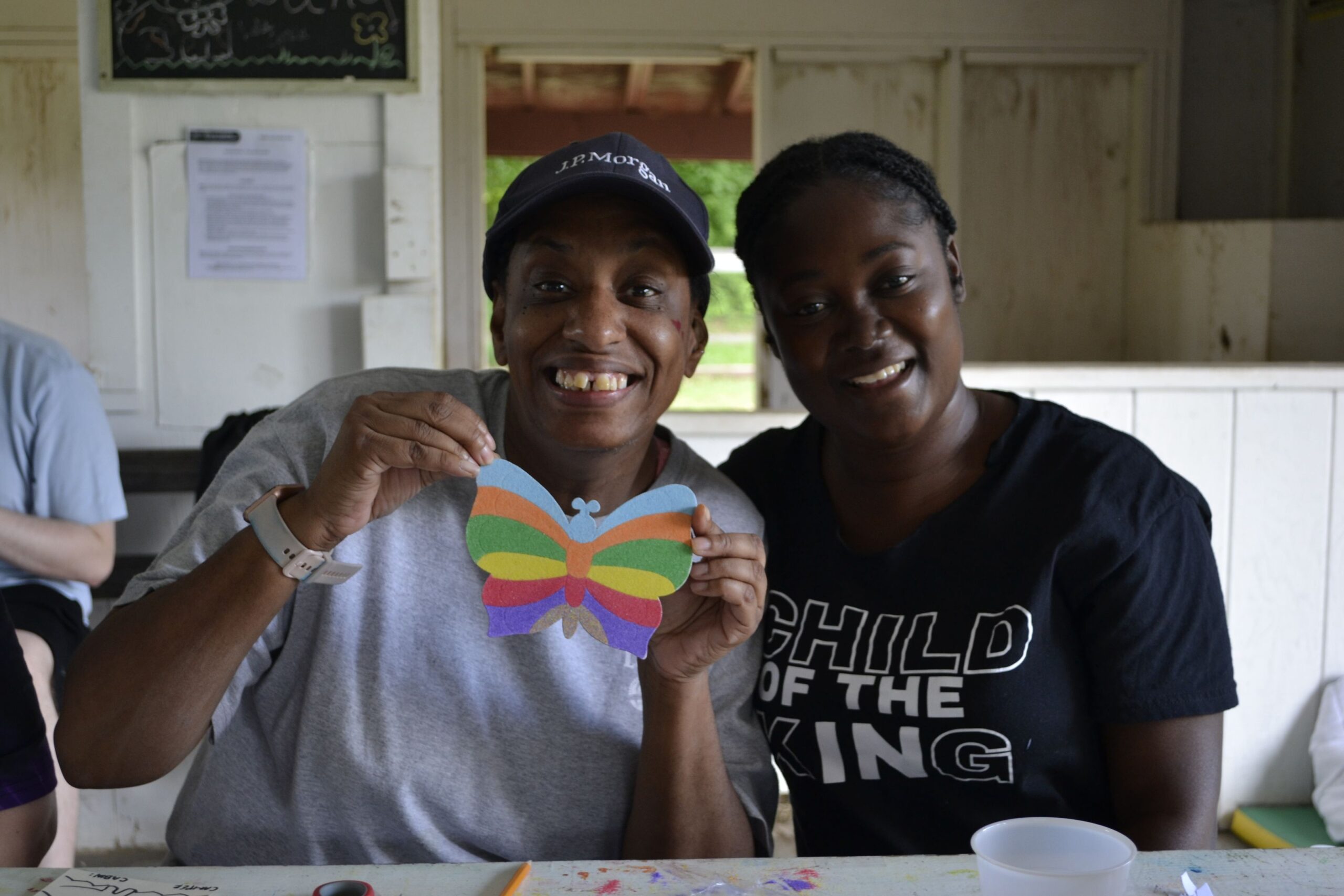 Camp Loyaltown campers show off their arts and crafts projects.