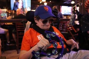 A Citizens resident shakes a tambourine at Karaoke Night.