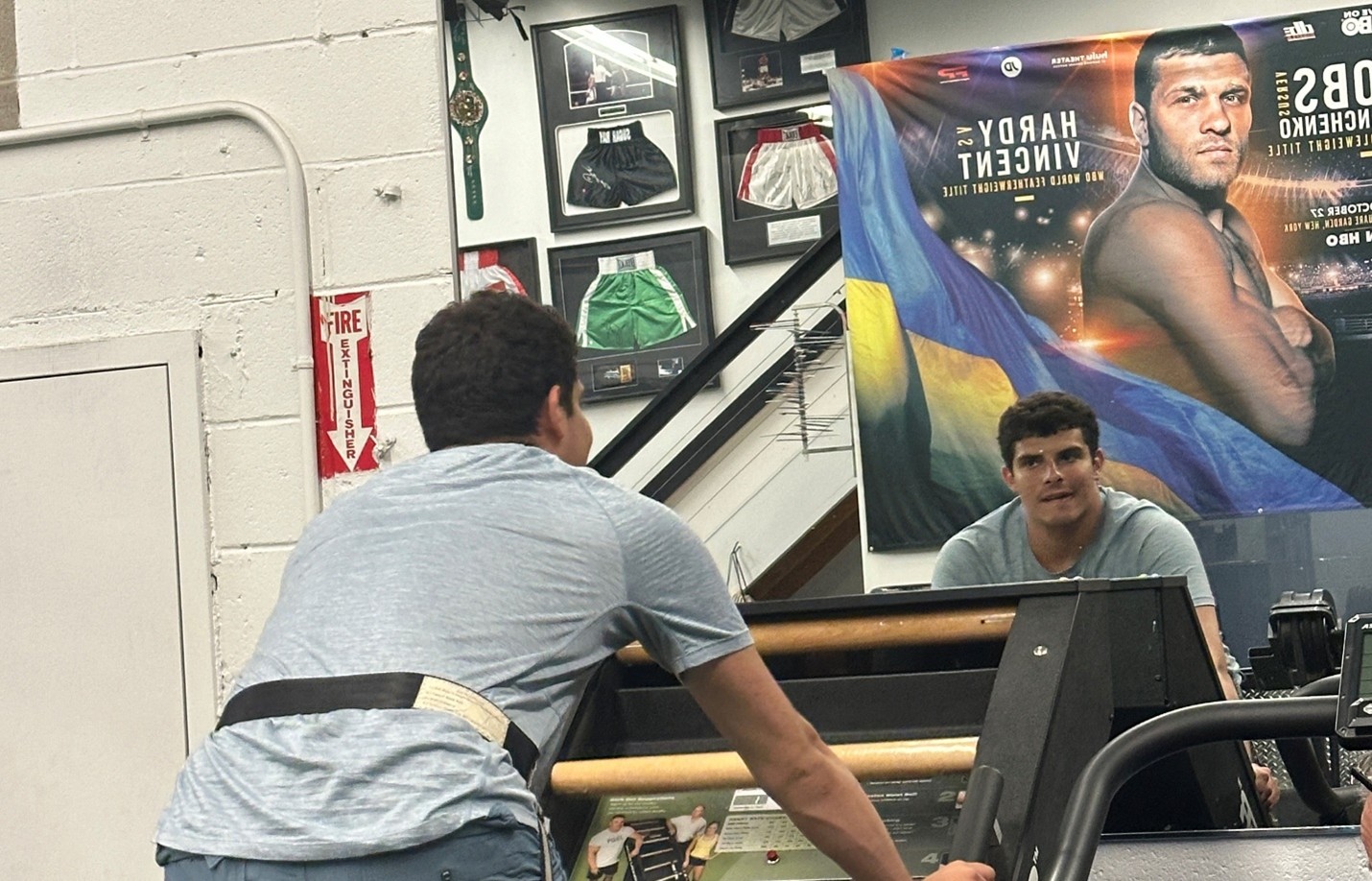 Jonathan Mendel exercises in front of the mirror at the gym.