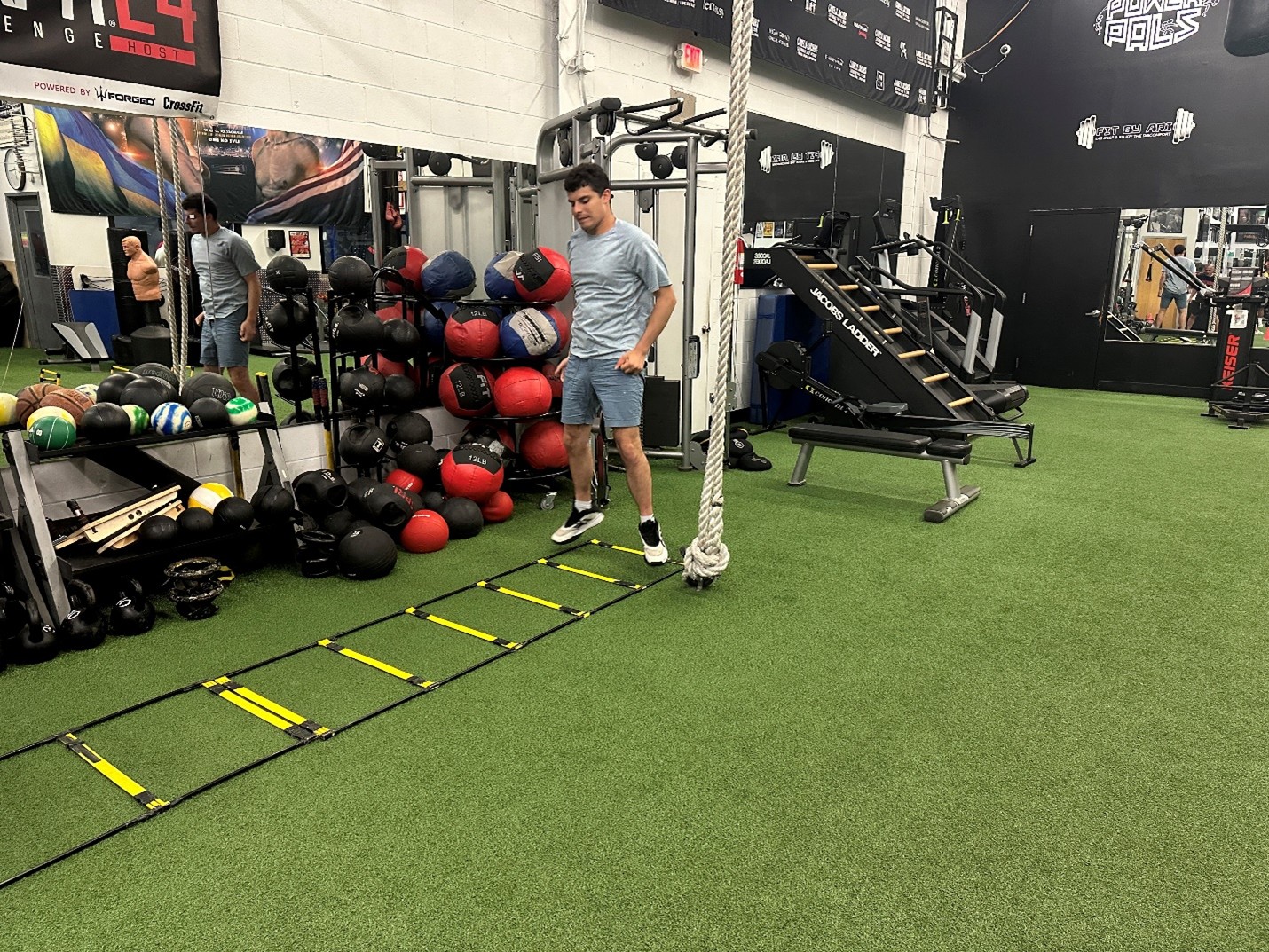 Jonathan Mendel does ladder exercises at the gym.