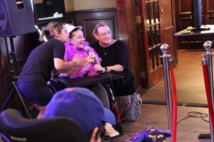 Citizens staff members sing Karaoke with a resident.