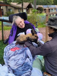 A resident at he Shoreham Intermediate Care Facility holds a bunny at the petting zoo