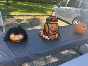Three decorated pumpkins on display on a table at the Fall Festival