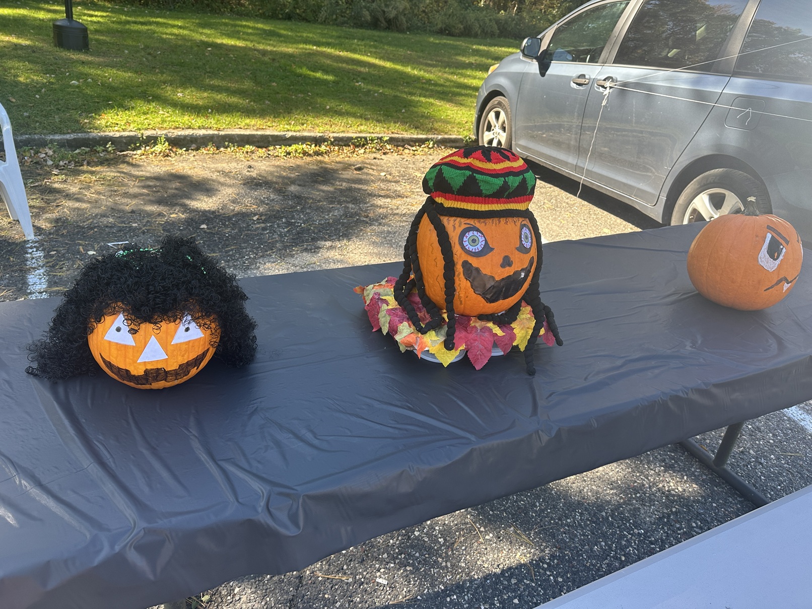 Three decorated pumpkins on display on a table at the Fall Festival