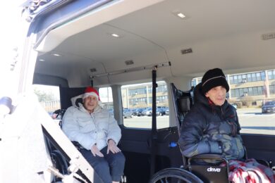 Two Helen Kaplan residents in the van on the way to drop off donations.