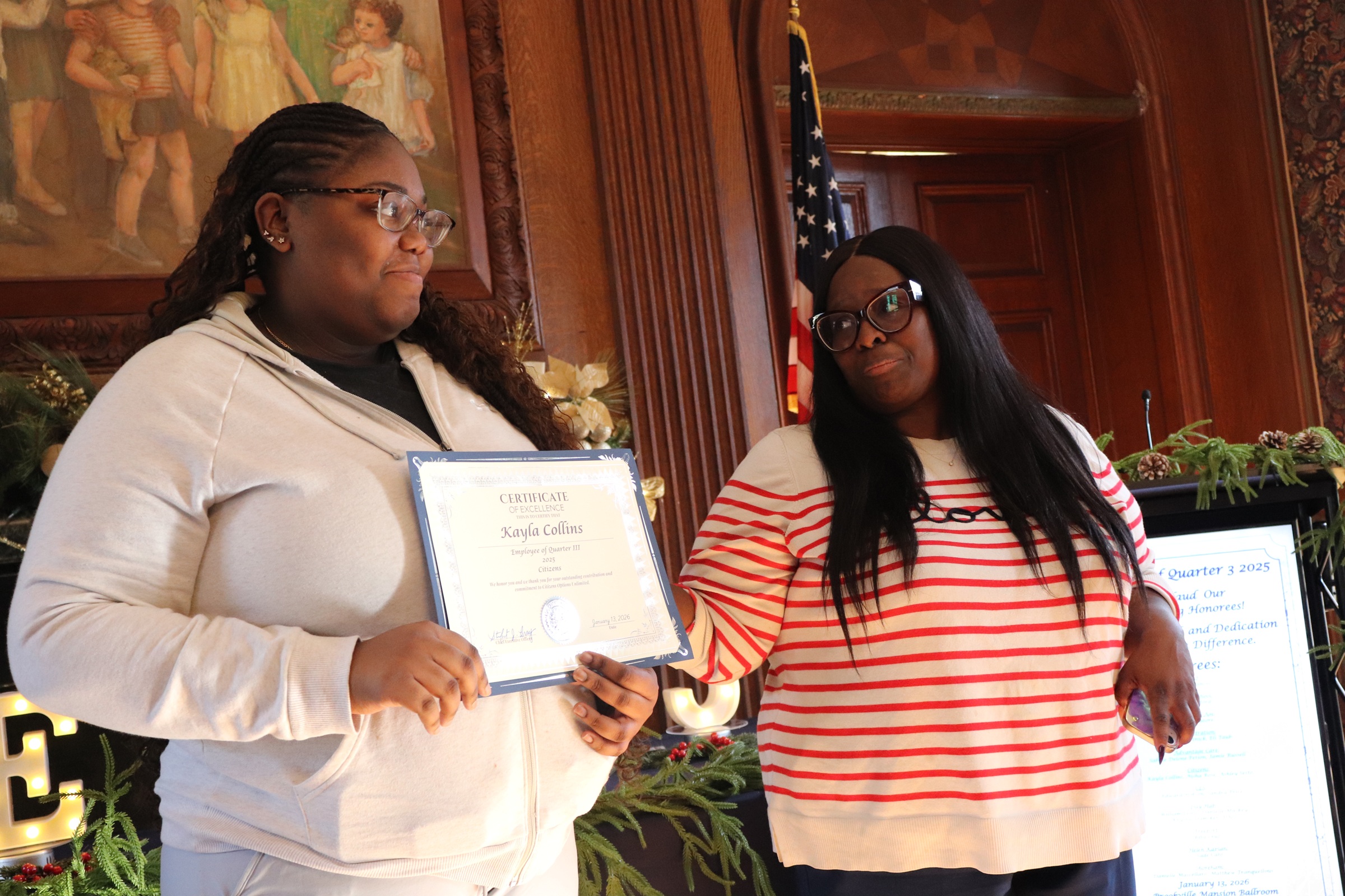 Kayla Collins and her Employee of the Quarter award and Assistant Director Karen Jones