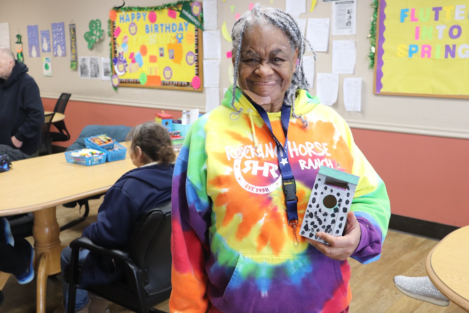 Ruth Henderson holds a birdhouse that she made at the Farmingdale hub site.