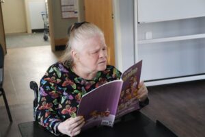 A shore Resident reads from a book about